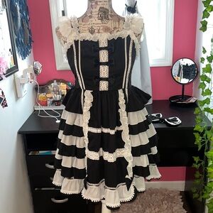 maid costume black and white dress with ruffles and a bow.